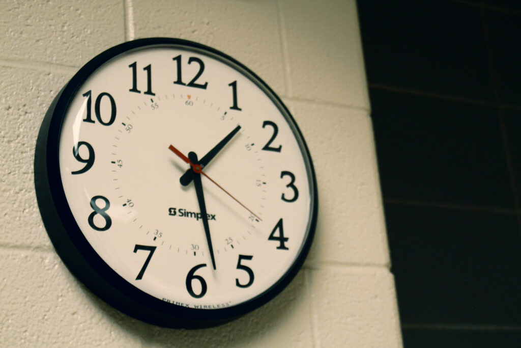 Round black analog wall clock