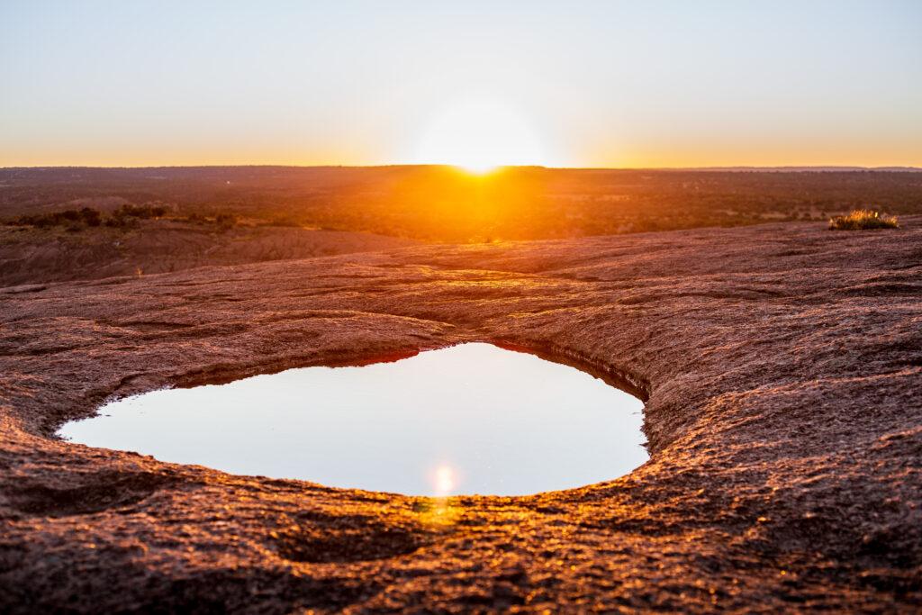 Sun setting in a reflective pool